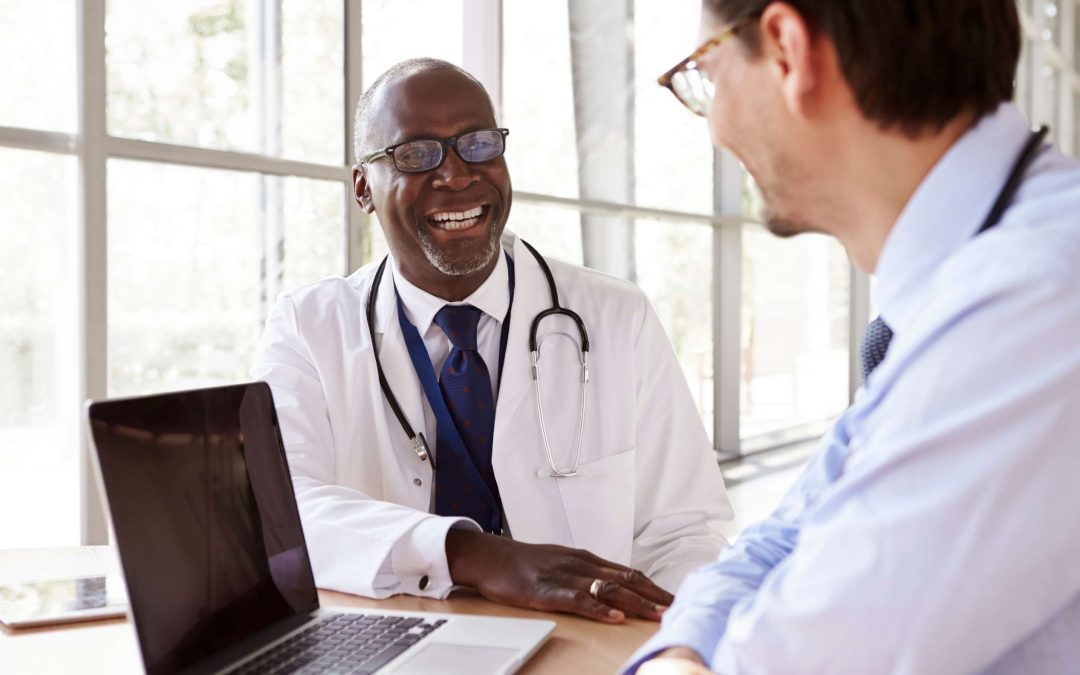 Professional healthcare IT team reviewing cybersecurity dashboards and compliance documentation in a modern office setting, representing HIPAA 2.0 updates and 2026 healthcare security readiness.