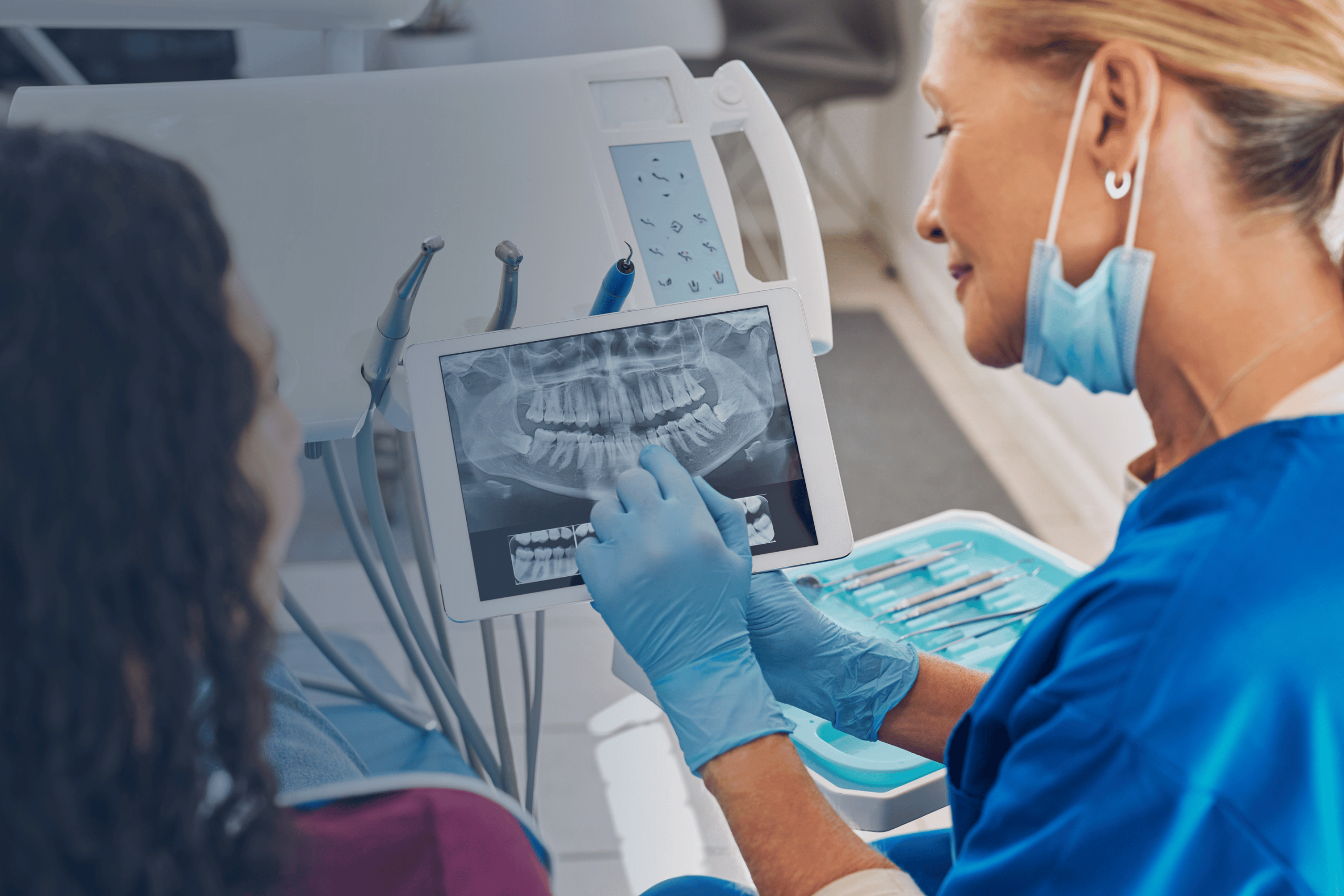 Dental Practice Staff Showing X-Ray to Patient Powered by ITS Managed IT Services